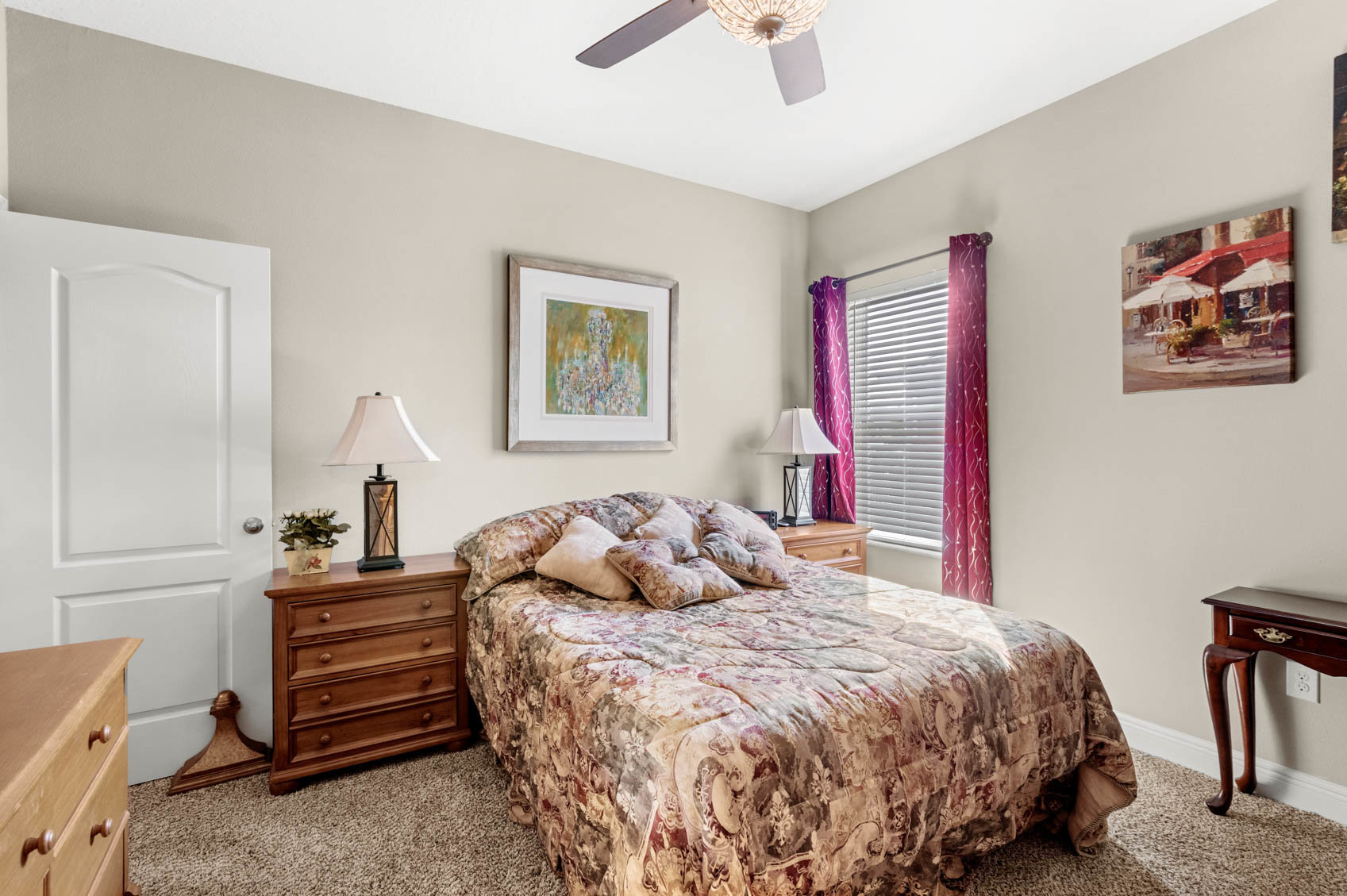 bedroom with full size bed and red patterned comforter